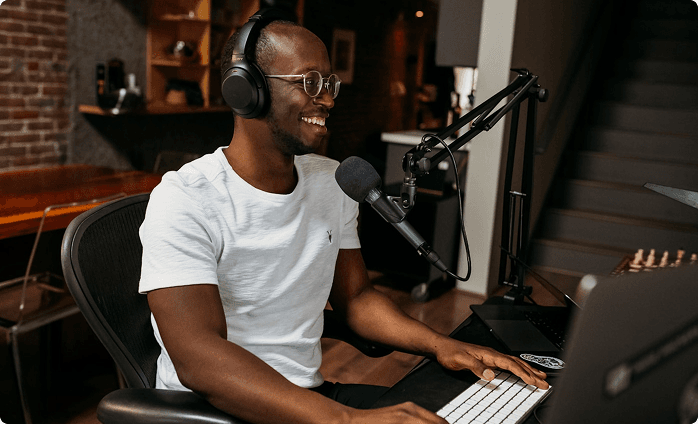 Content creator in studio setup with microphone and headphones