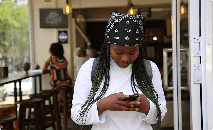 Young woman using smartphone to engage with content